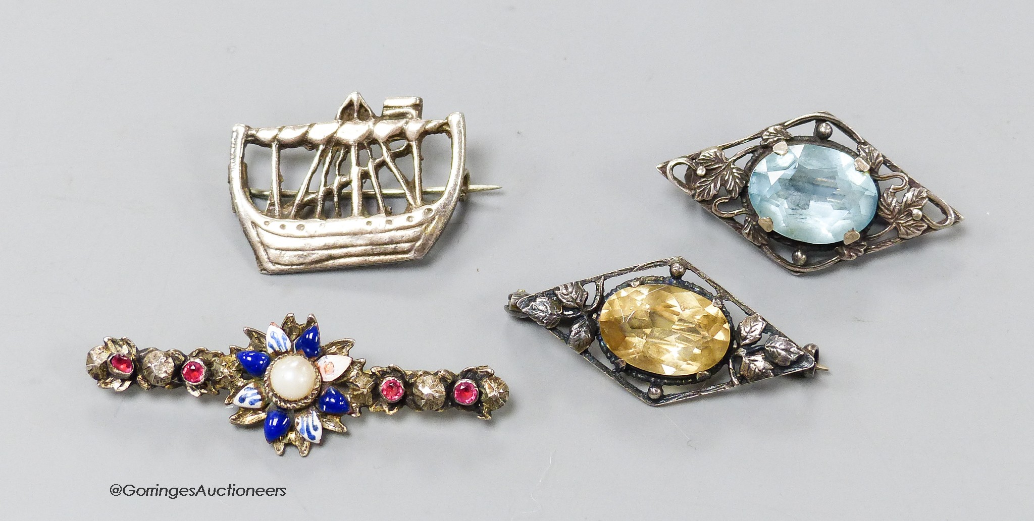 Two gem-set silver openwork lozenge-shaped brooches (possibly Scandinavian), a silver brooch in the form of a longship and an enamel and gem-set bar brooch (4)